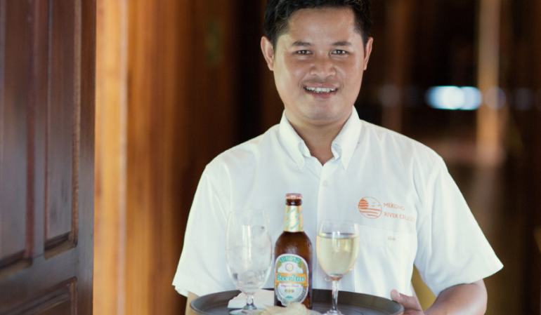 Serving Beerlaos on Laos river cruises